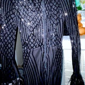 Black dress with feather sleeves and a dip in the front